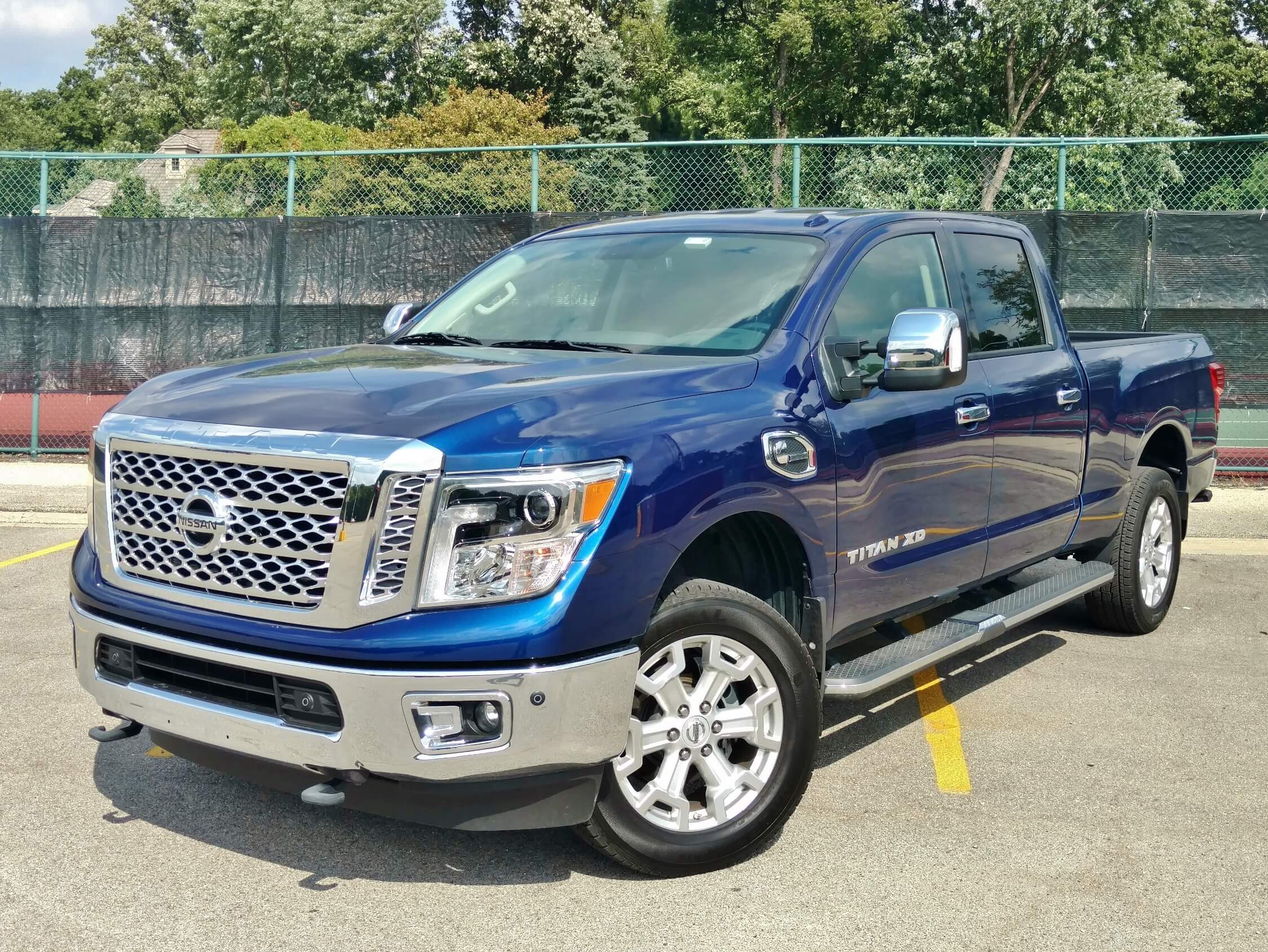 2017 Nissan Titan XD TD 4x4: in Deep Pearl blue and mirrored chrome nose bling this SL model = $57,255