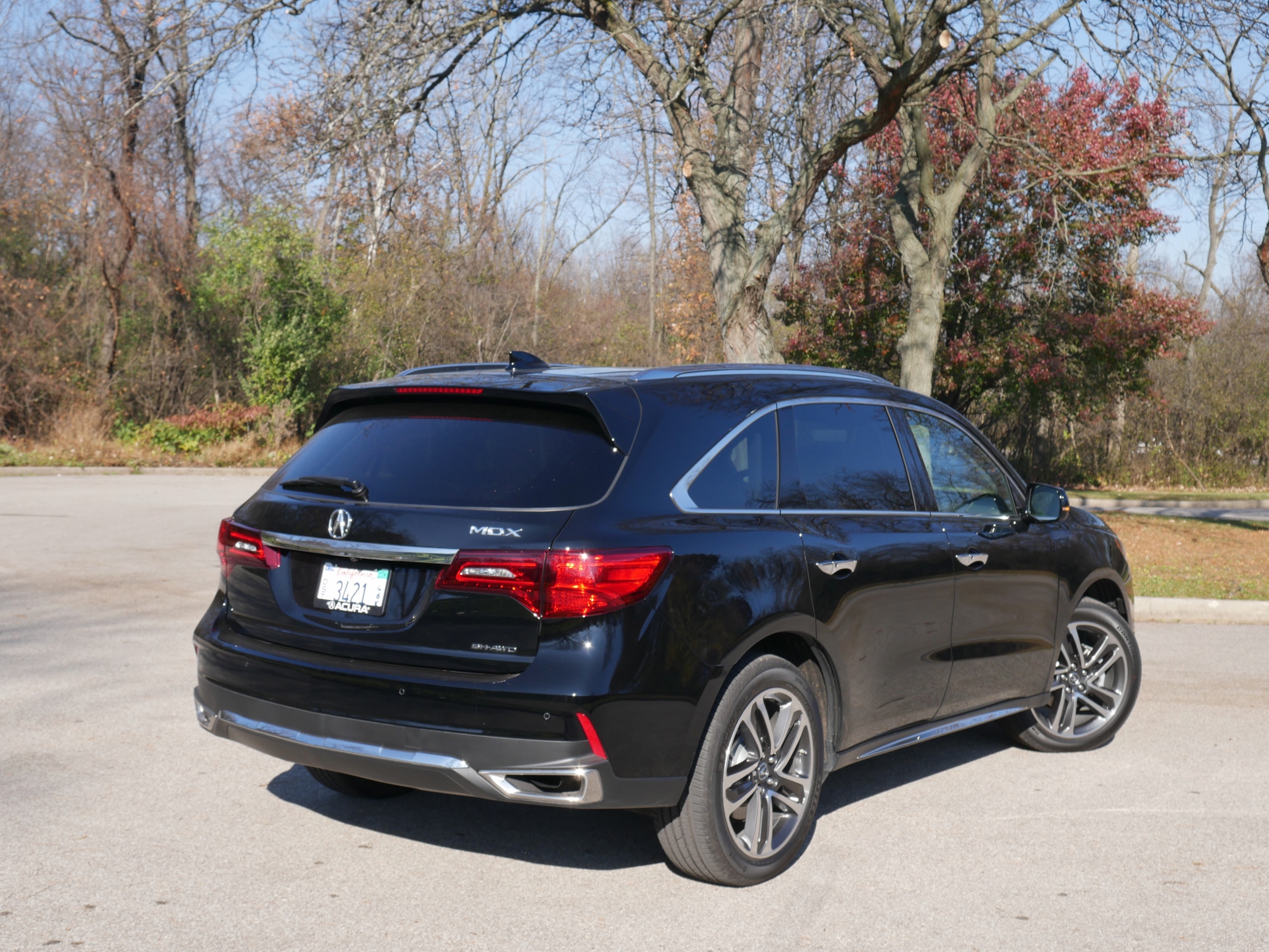 2018 Acura MDX SH-AWD: Raked C-pillar framing and bulging Kammback = sporty appeal; Twin, chrome tipped rectangular corner exhaust outlets are new.