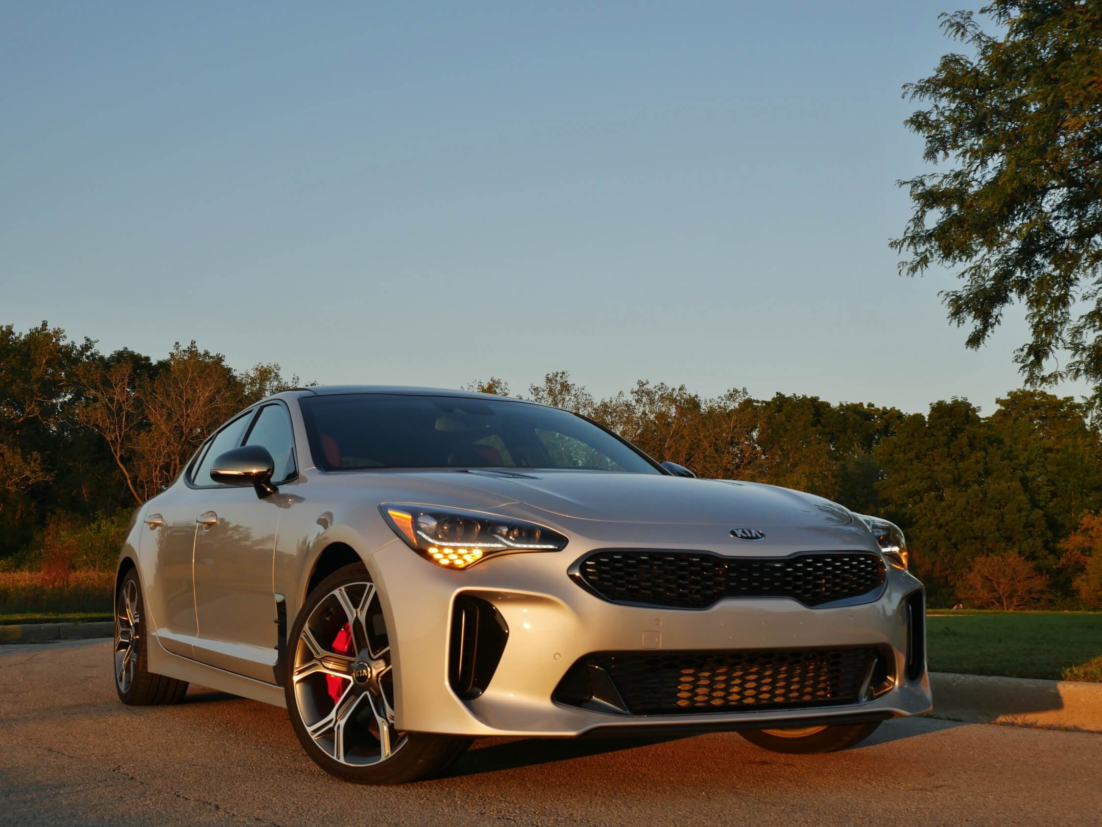 2018 Kia Stinger GT2 AWD: Sloped hood, short dual kidney impression dark lattice grille, scooped corner vertical fangs & boomerang LED headlamp DRLs takes no prisoners