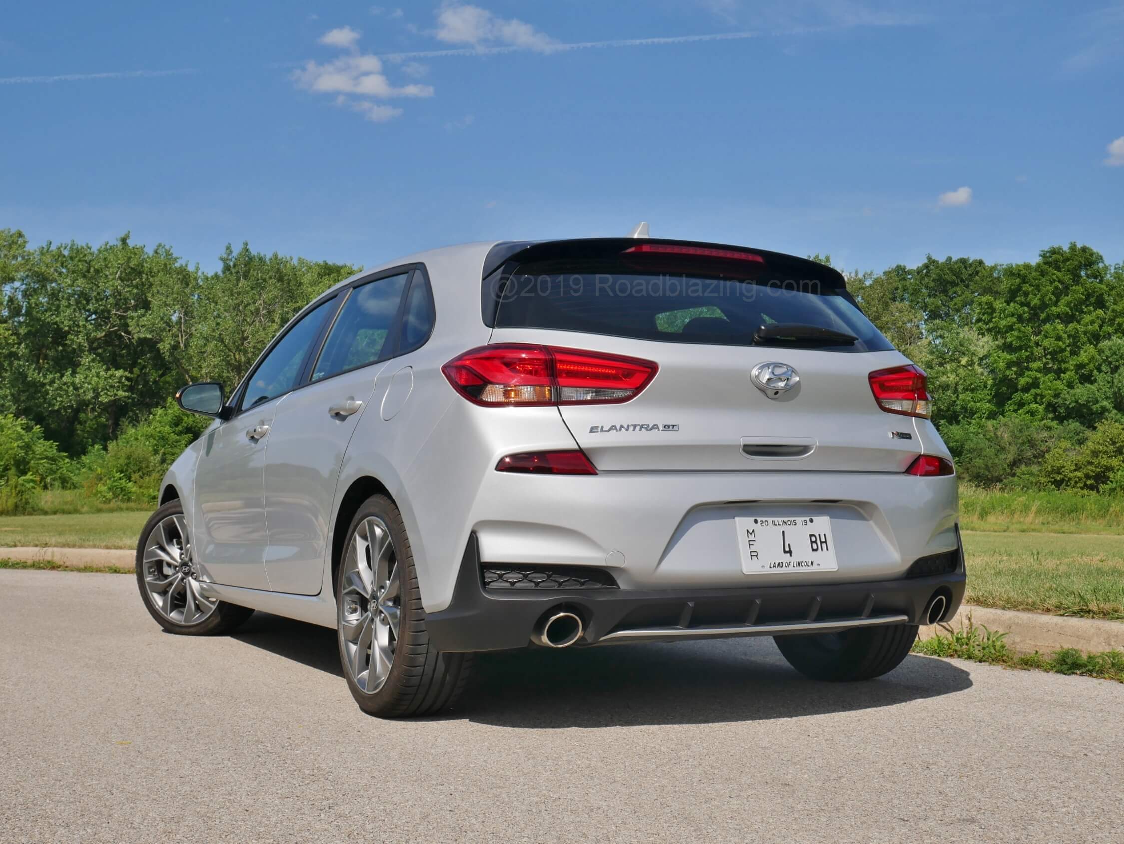 2019 Hyundai Elantra GT N-Line: Accentuating a rising Kammback rear end are reflectors relocated to flank the liftgate bottom. Honeycomb faux lower corner inlets and a diffuser split chrome dual exhaust tips.