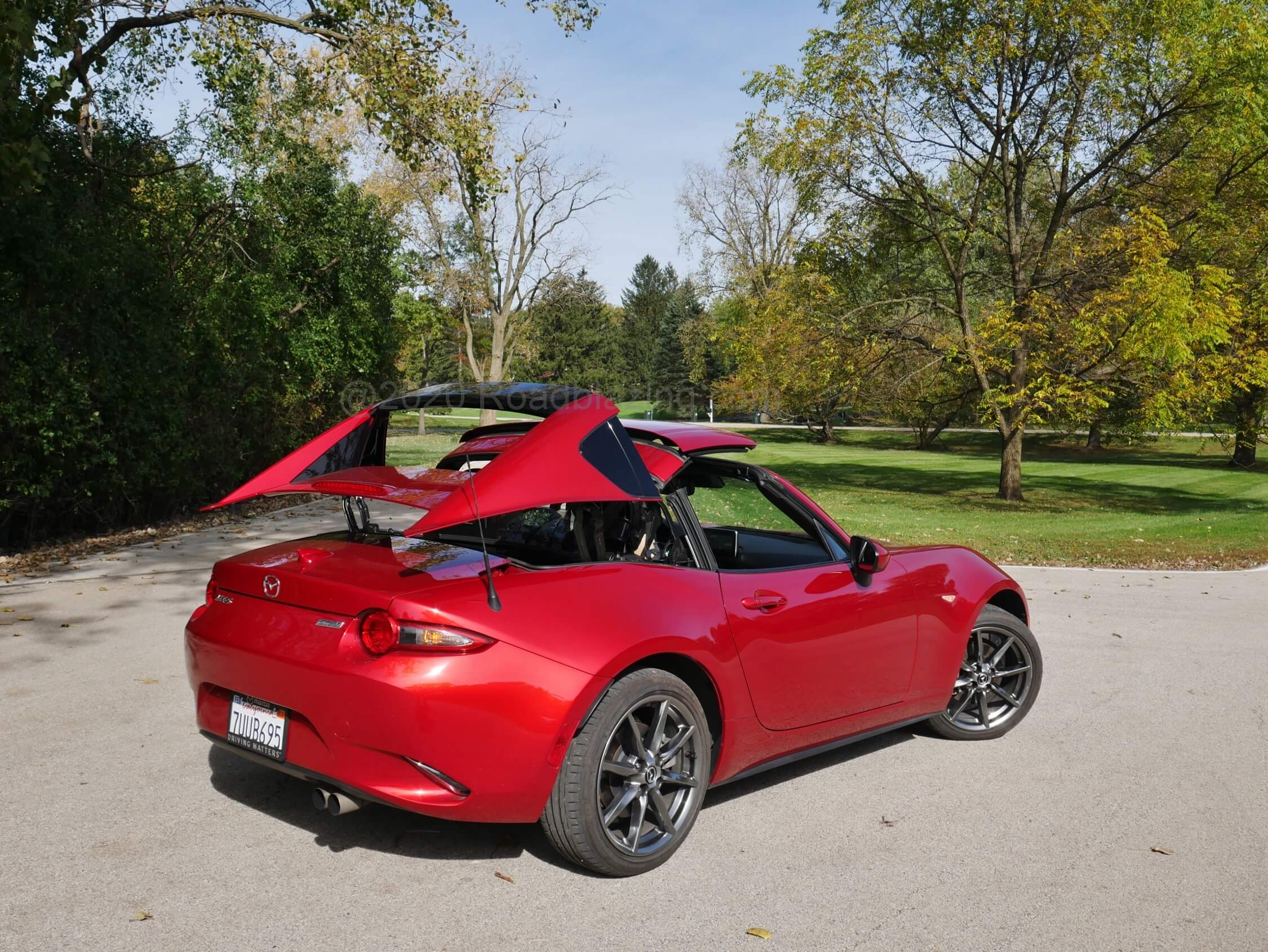 2020 Mazda MX-5 Grand Touring RF: can't be moving faster than 6 mph and all those electric arms open or close the targa top within 13 seconds by depressing and holding one of two center console switches