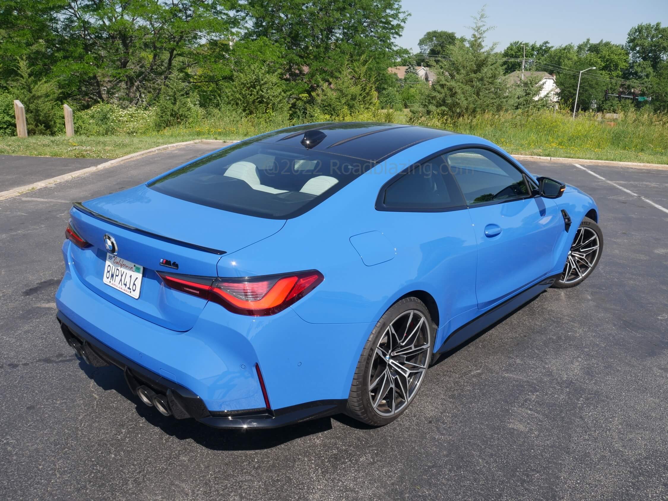 2022 BMW M4 Competition xDrive: sloped woven carbon fiber roof leads into raked backlight